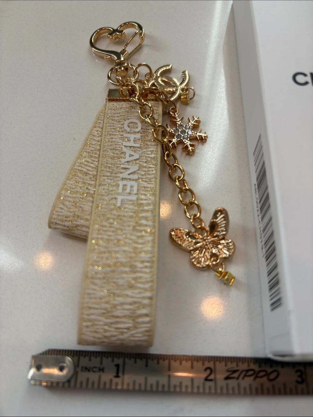 Beige and Gold Logo Strap Keychain with Charms